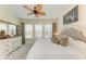 Inviting bedroom featuring a comfortable bed, natural light from three windows, and decorative artwork and dresser at 4253 Pond Brook Ct, Bradenton, FL 34211