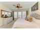 Cozy bedroom with a large bed, ample natural light from three windows, and a decorative dresser with a mirror at 4253 Pond Brook Ct, Bradenton, FL 34211