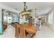 Open dining area and kitchen with modern lighting and decor, seamlessly connecting to the living room at 4253 Pond Brook Ct, Bradenton, FL 34211