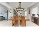 Open-concept dining area flows into the kitchen, featuring wood accents and modern pendant lighting at 4253 Pond Brook Ct, Bradenton, FL 34211