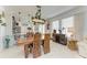 Cozy dining area with a rustic wood table, stylish lighting, and seamless access to the kitchen at 4253 Pond Brook Ct, Bradenton, FL 34211