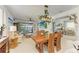 Open dining and living space features a wood table, decorative lighting, and access to the pool area at 4253 Pond Brook Ct, Bradenton, FL 34211