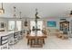 Open-concept living with a dining area, kitchen island, and comfortable seating, flooded with natural light at 4253 Pond Brook Ct, Bradenton, FL 34211