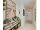 Bright entryway featuring a stylish console table with beach-themed décor and elegant lighting at 4253 Pond Brook Ct, Bradenton, FL 34211