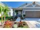 Inviting front entrance with landscaped flower beds and a cozy seating area at 4253 Pond Brook Ct, Bradenton, FL 34211