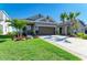 Charming single-story home with a well-manicured lawn, lush landscaping, and a two-car garage at 4253 Pond Brook Ct, Bradenton, FL 34211
