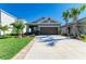 Charming single-story home featuring a concrete driveway, lush landscaping, and a well-manicured lawn at 4253 Pond Brook Ct, Bradenton, FL 34211