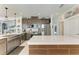 Open-concept kitchen boasts stainless steel appliances, quartz countertops, and wood-look accents on the island at 4253 Pond Brook Ct, Bradenton, FL 34211