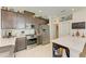 Well-lit kitchen featuring stainless steel appliances, upper cabinets, and a kitchen island with barstool seating at 4253 Pond Brook Ct, Bradenton, FL 34211
