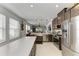 Spacious kitchen with stainless steel appliances, a large island with quartz countertops, and backyard views at 4253 Pond Brook Ct, Bradenton, FL 34211