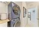 Modern laundry room with a stacked washer and dryer for space-saving efficiency at 4253 Pond Brook Ct, Bradenton, FL 34211