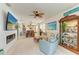 Open-concept living room with a fireplace, dining area, and decor with beach themes, creating a modern and airy space at 4253 Pond Brook Ct, Bradenton, FL 34211