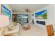 Bright living room with a modern fireplace, large TV, comfortable seating, and pool views at 4253 Pond Brook Ct, Bradenton, FL 34211