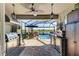 Charming screened lanai with full outdoor kitchen and beautiful view of the pool and lake at 4253 Pond Brook Ct, Bradenton, FL 34211