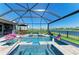 Gorgeous screened-in pool and spa with outdoor dining, sun loungers, and picturesque lake views at 4253 Pond Brook Ct, Bradenton, FL 34211