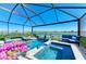 Beautiful screened-in pool area with a lake view, including seating area and lush landscaping at 4253 Pond Brook Ct, Bradenton, FL 34211