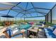 Beautiful screened-in pool with stylish outdoor seating, a hot tub, and serene water views at 4253 Pond Brook Ct, Bradenton, FL 34211