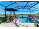 Gorgeous pool area with plenty of seating, a patio table and serene lake views at 4253 Pond Brook Ct, Bradenton, FL 34211