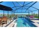 Inviting pool area with chairs, loungers, and a view of the lake for ultimate relaxation at 4253 Pond Brook Ct, Bradenton, FL 34211