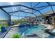 Fantastic screened-in pool with an attached spa, outdoor kitchen, lounge seating, and lake views at 4253 Pond Brook Ct, Bradenton, FL 34211