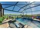 Serene screened-in pool and spa with lounge chairs, greenery, and tranquil lake views at 4253 Pond Brook Ct, Bradenton, FL 34211