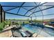Idyllic screened-in pool area with an attached spa, lounge chairs, and picturesque lake views at 4253 Pond Brook Ct, Bradenton, FL 34211