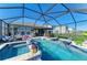 Inviting screened-in pool area with an attached spa, lounge chairs, and outdoor living space at 4253 Pond Brook Ct, Bradenton, FL 34211