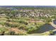 Aerial view of a neighborhood, golf course, and small lake at 4283 Southwell Way, Sarasota, FL 34241