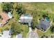 Aerial view of a home with a pool, surrounding landscaping, and neighboring houses at 4283 Southwell Way, Sarasota, FL 34241