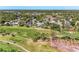 Aerial view of the home surrounded by lush landscaping and a golf course at 4283 Southwell Way, Sarasota, FL 34241