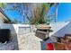 View of a backyard area with white gravel, storage containers, and recreational equipment at 4283 Southwell Way, Sarasota, FL 34241