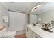 Bathroom with a modern vanity, marble countertop, updated fixtures and a shower with a geometric design at 4283 Southwell Way, Sarasota, FL 34241