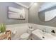 The bathroom features a decorative mirror, neutral paint and tile, and updated fixtures at 4283 Southwell Way, Sarasota, FL 34241