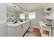 Bright bathroom features dual sinks, modern faucets, and a spacious vanity area with wood floors at 4283 Southwell Way, Sarasota, FL 34241