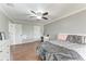 Cozy bedroom with wood look floors, ceiling fan, crown molding and large closet at 4283 Southwell Way, Sarasota, FL 34241