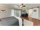 Bedroom features updated floors, an ensuite bathroom, and access to a private balcony at 4283 Southwell Way, Sarasota, FL 34241