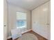 Bright bedroom featuring a window, wood floors, rug and spacious white closet at 4283 Southwell Way, Sarasota, FL 34241