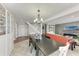 Open dining area seamlessly connects to the living room and features a modern chandelier and stairway at 4283 Southwell Way, Sarasota, FL 34241