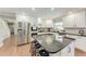 Bright and modern kitchen with stainless steel appliances and a large center island with seating at 4283 Southwell Way, Sarasota, FL 34241