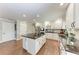 Spacious kitchen with white cabinets, granite countertops, and a large island with bar stools at 4283 Southwell Way, Sarasota, FL 34241