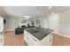 Open-concept kitchen features an island cooktop, white cabinets and open views of the living room at 4283 Southwell Way, Sarasota, FL 34241