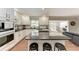 Modern kitchen featuring stainless steel appliances, a center island, and seamless access to the living area at 4283 Southwell Way, Sarasota, FL 34241