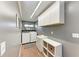 Efficient laundry room with washer, dryer, sink, storage cabinets and shelves at 4283 Southwell Way, Sarasota, FL 34241