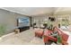 Cozy living room with comfortable seating, French doors to outside pool, and neutral decor at 4283 Southwell Way, Sarasota, FL 34241