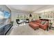 Cozy living room with comfortable seating, French doors to outside pool, and neutral decor at 4283 Southwell Way, Sarasota, FL 34241