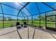 Relaxing covered patio with pavers and a scenic golf course view at 4283 Southwell Way, Sarasota, FL 34241