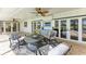 The covered patio offers comfortable seating, a ceiling fan and an outdoor TV at 4283 Southwell Way, Sarasota, FL 34241