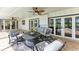 The covered patio offers comfortable seating, a ceiling fan and an outdoor TV at 4283 Southwell Way, Sarasota, FL 34241