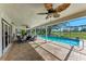 Relaxing covered patio with pool, fan, and golf course view at 4283 Southwell Way, Sarasota, FL 34241
