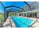 Relaxing screened pool area features a large sparkling pool and an outdoor dining area at 4283 Southwell Way, Sarasota, FL 34241